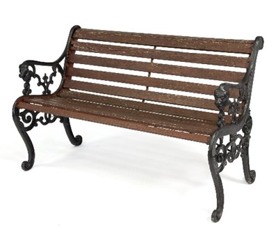 Lot 297 - A garden bench with cast iron ends, the arms...