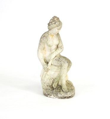 Lot 299 - A reconstituted stone figure of a seated nude,...