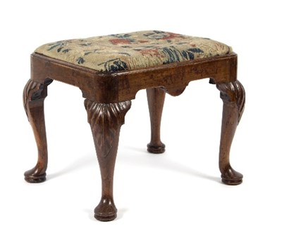 Lot 301 - A George I walnut stool, with carved acanthus...