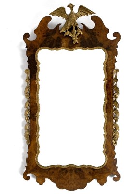 Lot 397 - A Georgian and later walnut fret carved mirror,...