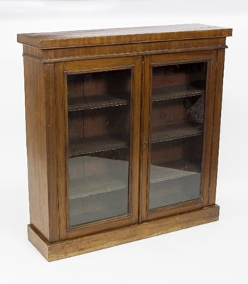 Lot 402 - A mahogany bookcase enclosed by glazed panel...