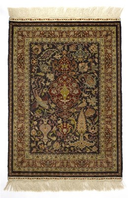 Lot 425 - A silk rug, with central medallion, birds and...