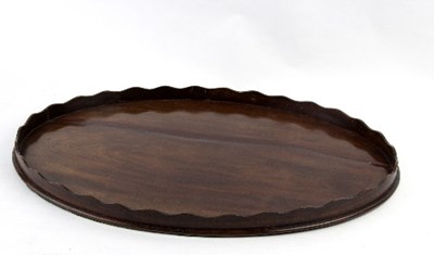 Lot 451 - A 19th Century mahogany oval tray with wavy...