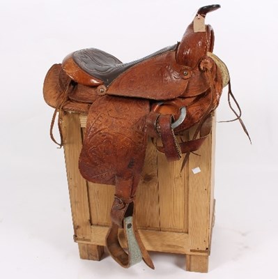 Lot 504 - A Western saddle with tooled decoration and...