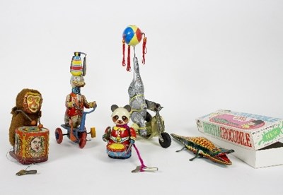 Lot 510 - A group of tinplate clockwork toys comprising...