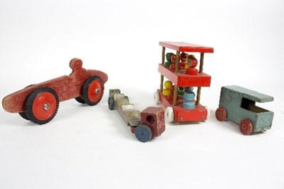 Lot 516 - A small group of wooden toys to include a...