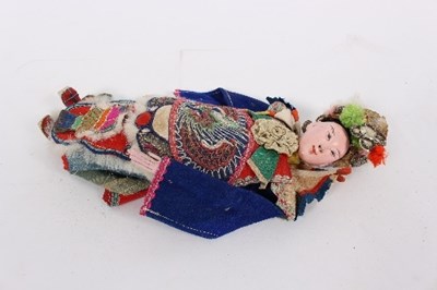 Lot 525 - A Chinese doll with painted head and hands...