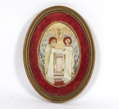 Lot 530 - An embroidered oval panel of two angels and a...