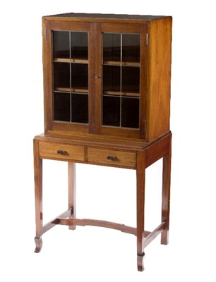 Lot 2 - A Cotswold School walnut cabinet enclosed by a...