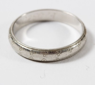 Lot 540 - A platinum wedding band by Boodle & Dunthorne...