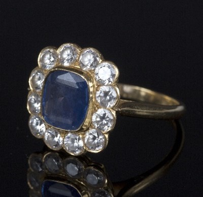 Lot 549 - A sapphire cluster ring, the central cushion...