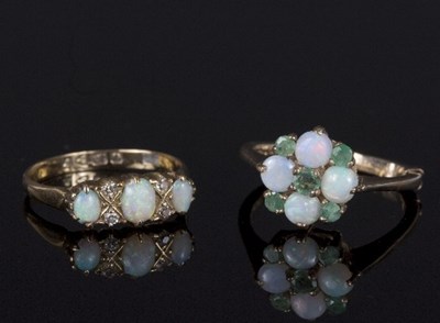 Lot 558 - An opal and diamond dress ring, set three oval...