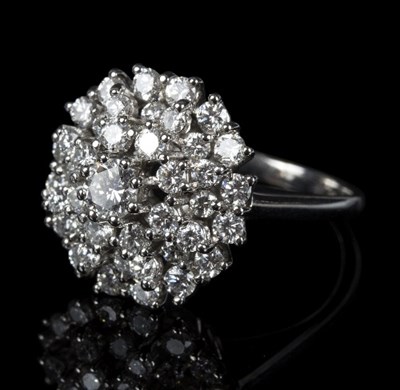 Lot 579 - A diamond cluster ring, the central brilliant...