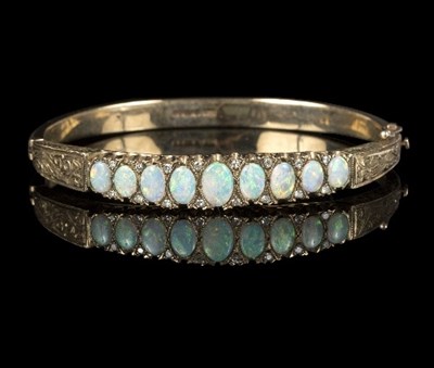 Lot 582 - A Victorian opal and diamond bangle, set nine...