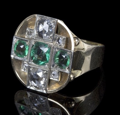 Lot 587 - A diamond and green garnet dress ring, the...