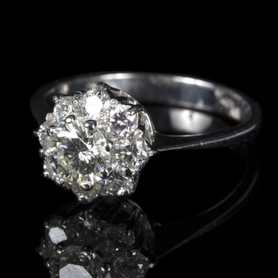 Lot 588 - A diamond cluster ring, the central round...