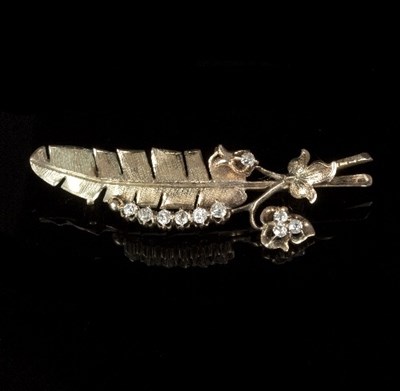 Lot 595 - A diamond brooch of feather and leaf spray...