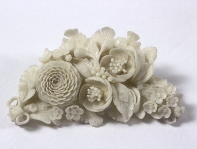 Lot 601 - A ceramic floral spray brooch, 8cm long, in a...