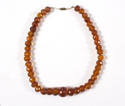 Lot 611 - A strand of graduated faceted amber beads,...