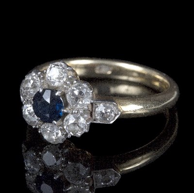 Lot 618 - A sapphire and diamond cluster ring, the...