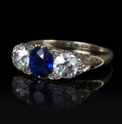 Lot 620 - A sapphire and diamond three-stone ring, the...