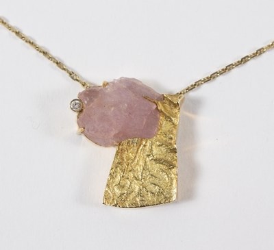 Lot 623 - An 18ct gold, rose quartz and diamond pendant,...