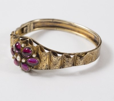 Lot 625 - A Victorian gem set hinged bangle, the central...