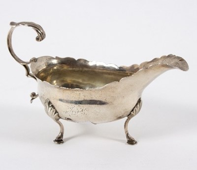 Lot 669 - A George III silver sauceboat, Charles Hougham,...