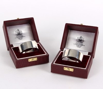 Lot 699 - Two silver napkin rings, Asprey, London 1988,...