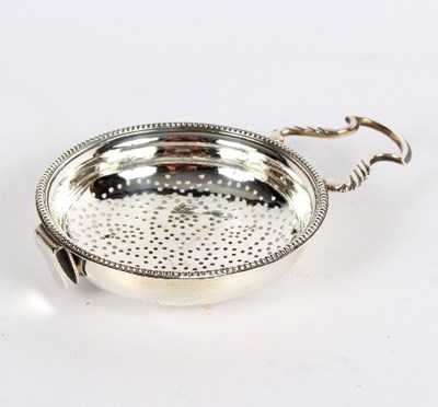 Lot 735 - A George III silver lemon strainer, William...