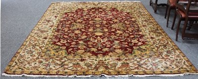 Lot 804 - An Eastern style carpet with central red...