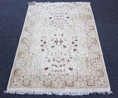 Lot 807 - A cream ground rug, Tree of Life design within...