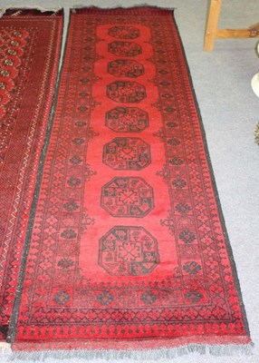 Lot 817 - An Afghan runner, 290cm x 82cm and a Bokhara...