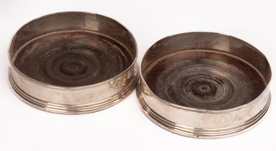 Lot 166 - A pair of George III silver wine coasters