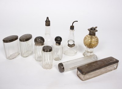 Lot 29 - A quantity of silver mounted glass scent...