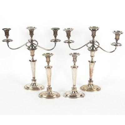 Lot 51 - Four Sheffield plate candlesticks of Adam...