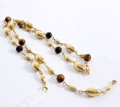 Lot 71 - An 18ct gold and tiger's eye necklace, the...