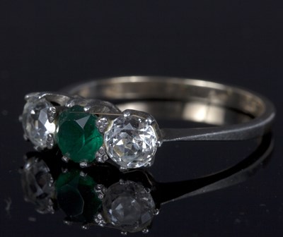 Lot 96 - A three-stone dress ring set colourless and...