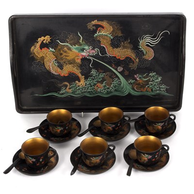 Lot 311 - An Oriental lacquered tea set on a tray,...