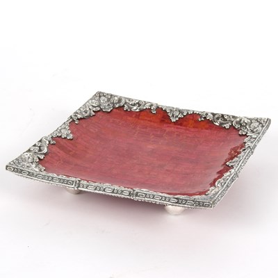 Lot 314 - A square dish with Eastern white metal border...