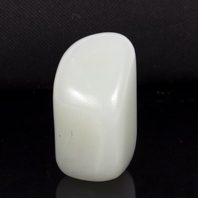 Lot 317 - A jade worry stone of pale celadon colour, 5cm...