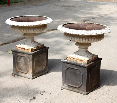 Lot 624 - A pair of cast iron urns, of circular form...