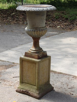 Lot 625 - A cast iron campana urn on stone plinth,...