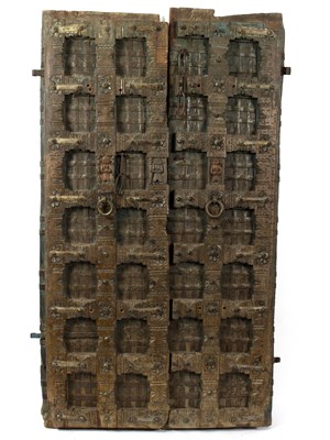 Lot 648 - A pair of Eastern carved wooden doors with...