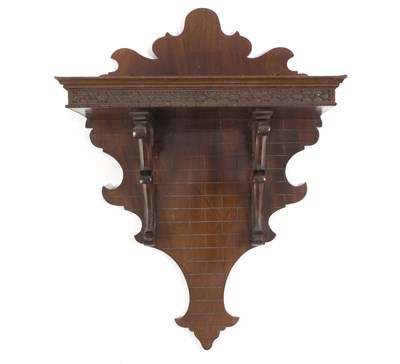 Lot 660 - A Victorian mahogany wall bracket, on scroll...