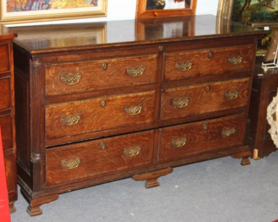 Lot 672 - A George III oak mule chest, the hinged cover...