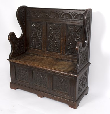 Lot 680 - A late 19th Century carved oak hall seat in...