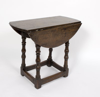 Lot 682 - A small oak two-flap coffee table raised on...