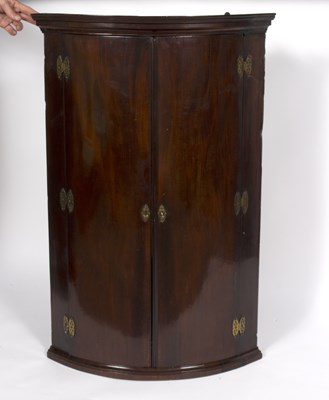 Lot 685 - A late 18th Century mahogany bowfront corner...