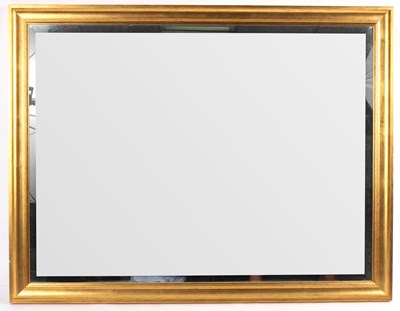 Lot 694 - A rectangular wall mirror in a gilded frame,...